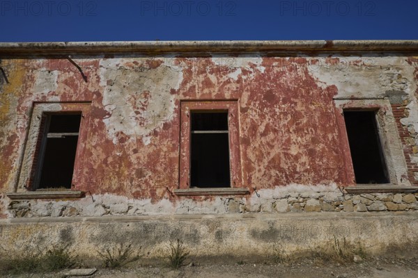 Lost Place, The facade of a dilapidated building with red and white discolouration, Radio Station,