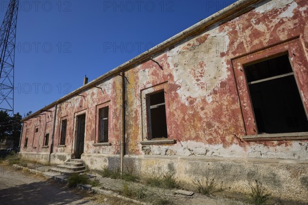 Lost Place, Long abandoned building with peeling red paint and open entrance, Radio Station, WW2,