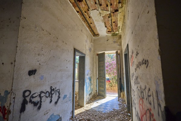 Lost Place, Abandoned hallway with graffiti and open doors, Flooded with light in a dilapidated