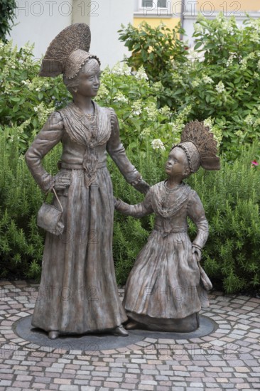 Two bronze sculptures, Überlingen women in festive traditional costume, created in 2023 by the