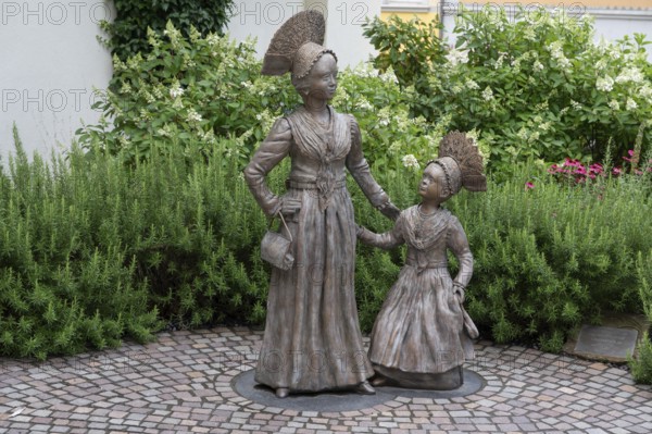 Two bronze sculptures, Überlingen women in festive traditional costume, created in 2023 by the