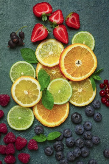 Mix of fruits and berries, set, assortment, sliced citrus fruits, raspberries, blueberries, mint