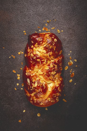 Braided, sweet bread pie, with sliced almonds, breakfast, braided bread, brioche, on a dark