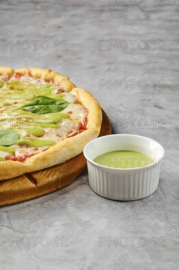 This dish features a freshly baked pizza with a golden crust adorned with toppings like fresh