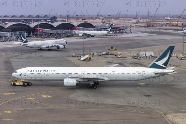 A Cathay Pacific Boeing 777-300 aircraft with the registration B-HNH at Chek Lap Kok Airport (HKG)