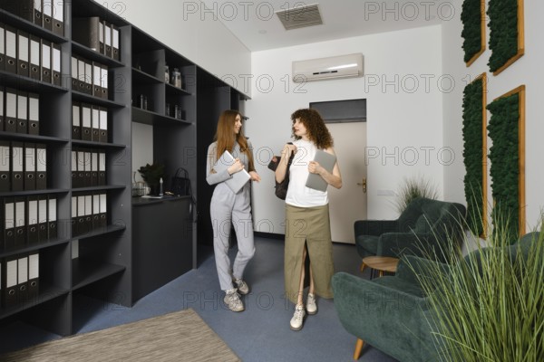 Two women engage in a lively conversation about women's health initiatives in a stylish office