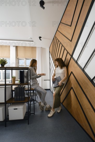 Two women stayed up late discussing their app for monitoring women's health in a startup office