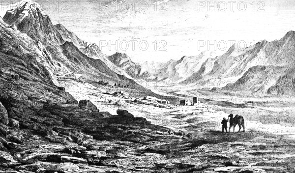 Barren mountain landscape in Turkistan, valley, scree, rocks, man leading camel, house, solitude,