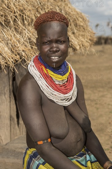 Woman of the Nyangatom ethnic group, also called Bume, with colourful bead necklaces and the