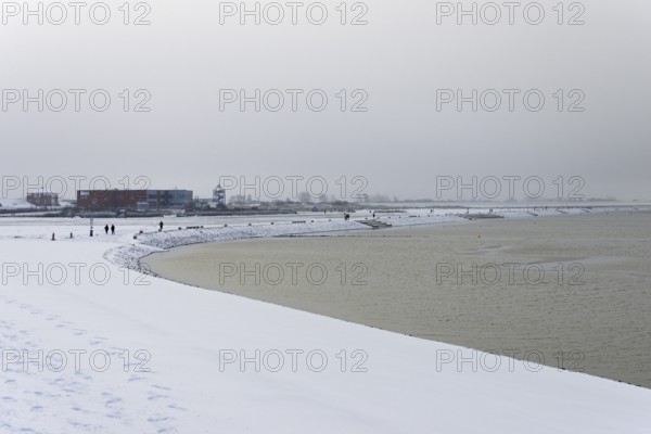 Winter day, onset of winter, snow on the North Sea coast, snow-covered beach promenade of
