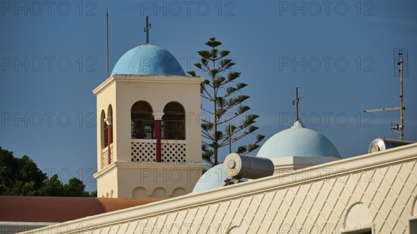 Church, Panagia Agia Paraskevi, building with blue bell tower and dome, surrounded by antennas, Kos