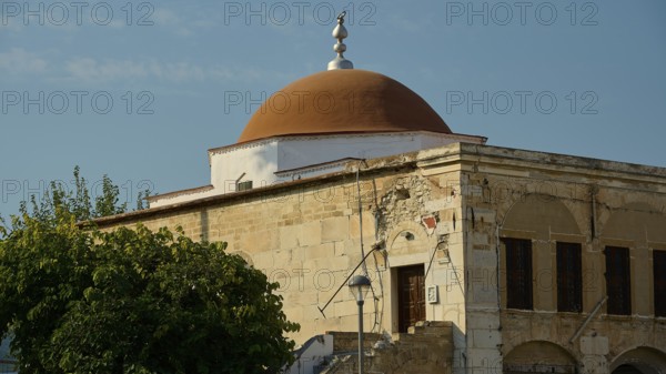 Defter-dar Mosque, Eleftherias Square, Old building with red dome and stone walls under a clear