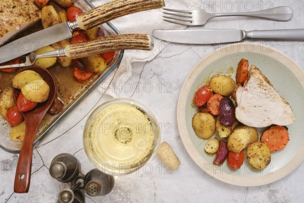 A plate with tender slices of turkey breast alongside colourful roasted vegetables, including