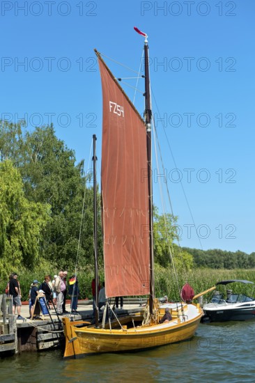Tourists looking at a Zeesen boat at the jetty, Krummin, Usedom Island, Mecklenburg-Western