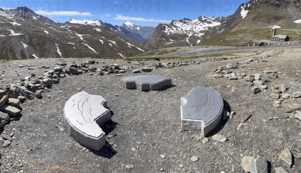 In front three orientation boards on stone for landscapes and mountain peaks at viewpoint next to