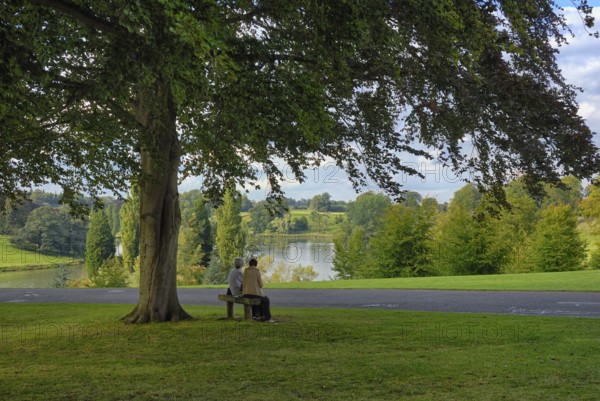 Two woman on a bench in the park of Blenheim Palace, the largest non-royal aristocratic residence