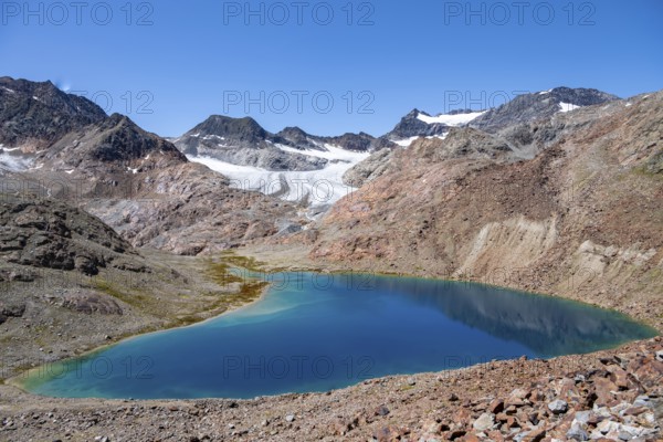 View of blue glacial lake in rocky mountain landscape, behind Königshofspitz, Schwarzwandspitz and