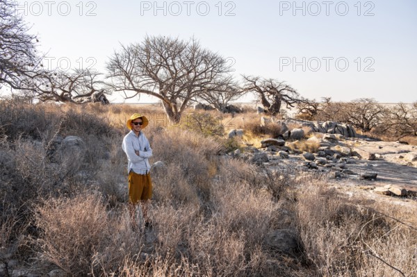 Tourist, African baobab or baobab tree (Adansonia digitata), Dry landscape, Kubu Island (Lekubu),