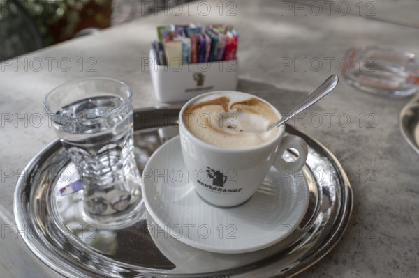 Cappuccino served with a glass of water, Bressanone, Italy