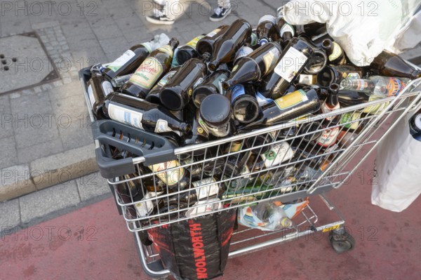 Shopping trolley overflowing with empty beer bottles on the mountain, Erlanger Bergkirchweih,