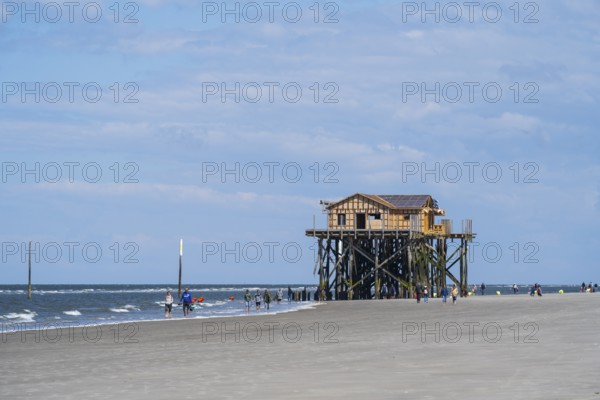 Pile dwelling and people on the beach, low tide, cloudy, Sankt Peter Ording, Eiderstedt, North