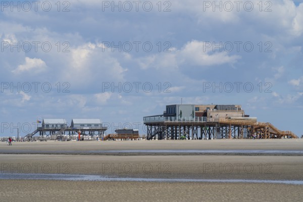 Pile dwellings on the beach, low tide, cloudy, Sankt Peter Ording, Eiderstedt, North Frisia, North