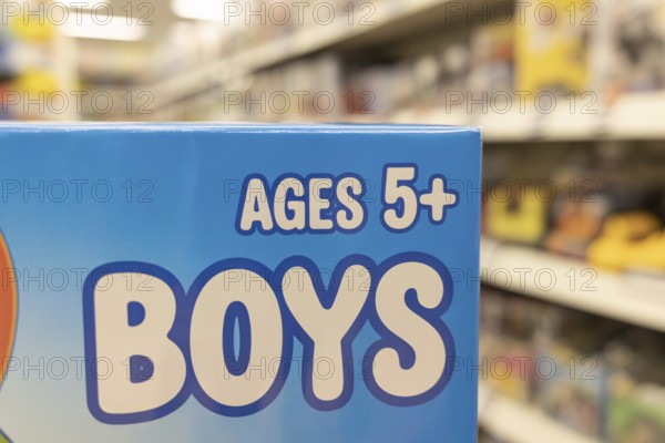 Close-up of Ages 5+ Boys text on blue toy packaging highlighting color gender coding. Generative