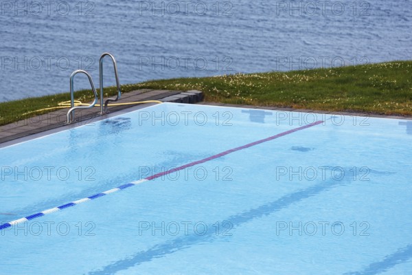 View from above of swimming pool by the sea, thermal bath, heated outdoor pool in Hofsos at the