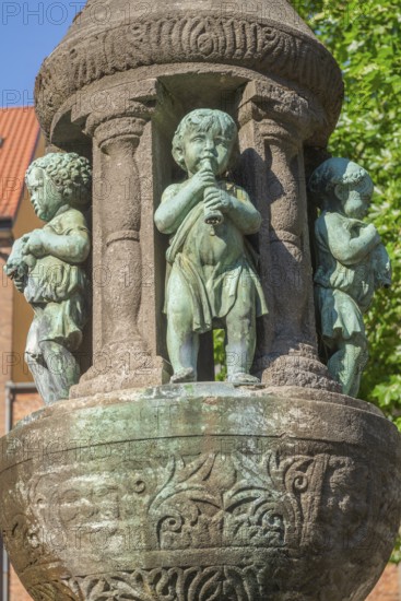 Tower wind fountain at St Peter's Cathedral, three musicians on the fountain column playing