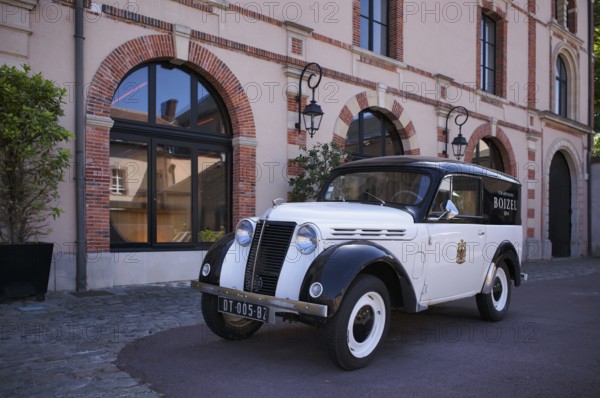 Black and white Renault Juvaquatre Editorial vintage car in front of headquarters, head office,
