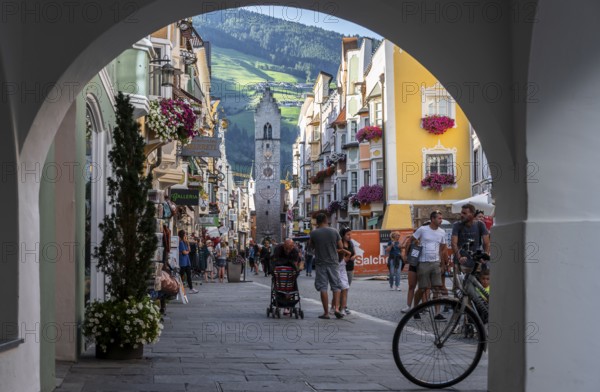 Passageway, old town, colourful houses in the main street, Zwölferturm tower at the back, Sterzing,