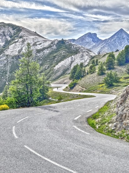 Photo with reduced dynamic saturation HDR of south ramp ascent of steep pass road with tight curves