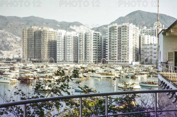 High rise apartment buildings and boats including yachts view from Royal Hong Kong Yacht Club,