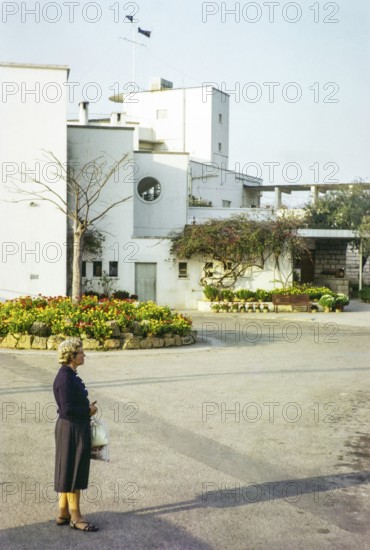 European woman standing next to Royal Hong Kong Yacht Club, Kellet Island, Causeway Bay, Hong Kong,