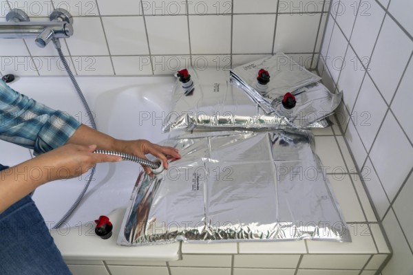 Filling a 10 litre water bag, for storing drinking water at home, as an emergency reserve in the