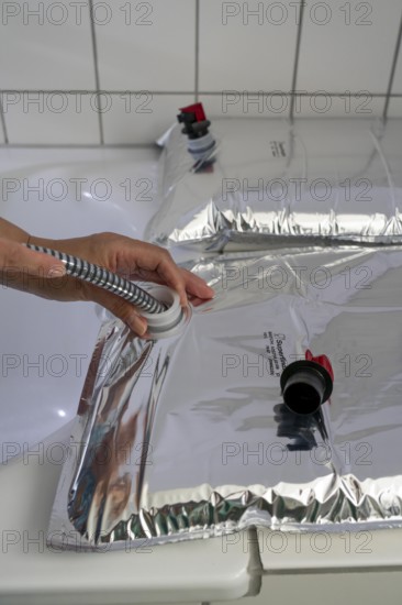 Filling a 10 litre water bag, for storing drinking water at home, as an emergency reserve in the