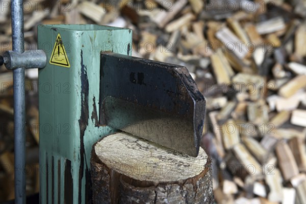 Firewood, splitting with a log splitter, axe