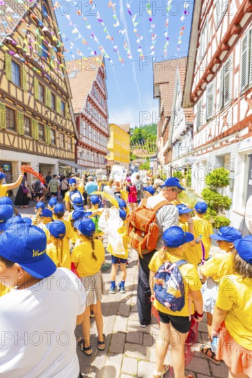 Children wear yellow clothes and blue caps at the street festival, 950 years of Calw, parade Calw,