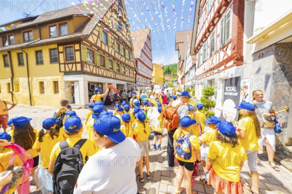 Children in yellow clothes enjoying a street party, 950 years Calw, parade Calw, Black Forest,