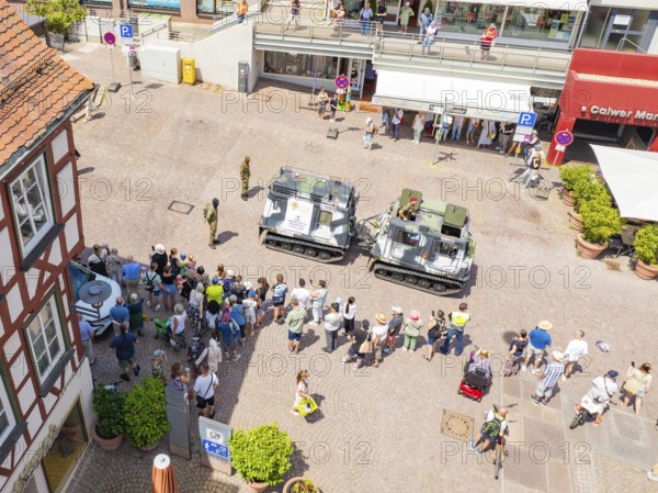 Street view with assembled spectators and military vehicles at an event, 950 years of Calw, Calw