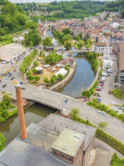 Aerial view of a cityscape with river, park and bridge in green surroundings, 950 years of Calw,