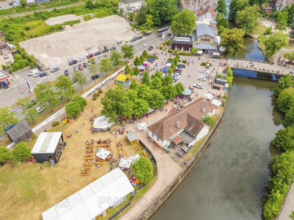 View of an event with tents and facilities along a river, 950 years of Calw, Calw parade, Black