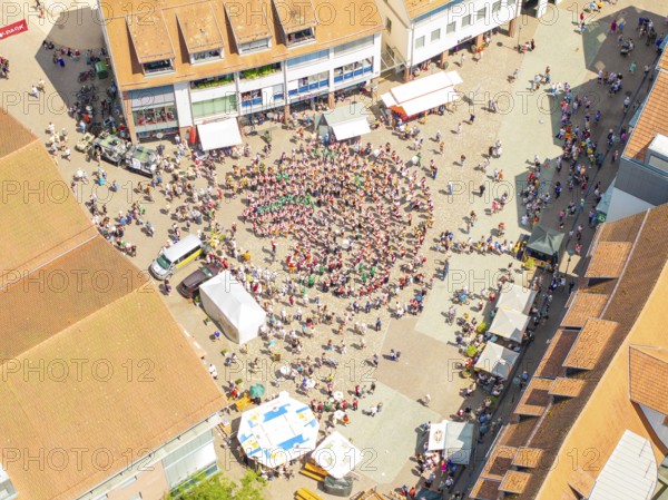 Vivid aerial view of a square where a crowd is taking part in a public celebration, 950 years of