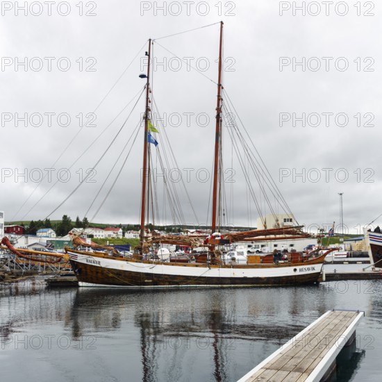 Sailing boat in the harbour, fishing village at Skjalfandi Bay, rain clouds, Husavik, Húsavík,
