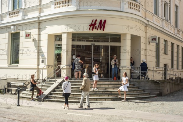 People at the entrance to the Hennes and Mauritz, H&M, department store in Ystad, Skåne County,