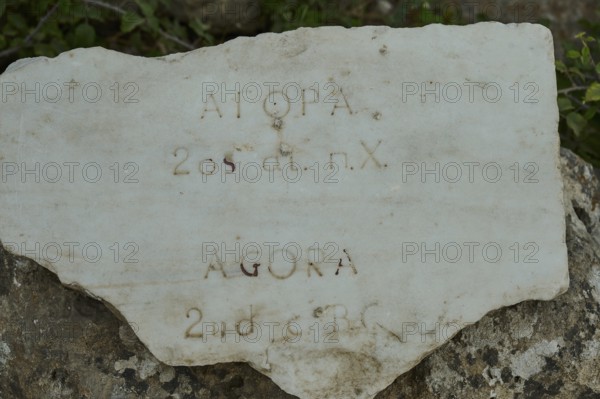 Inscribed ancient stone with inscription in various languages, Ancient Agora, Kos Town, Kos,
