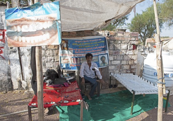 Indian man at a dentist stand in the Thar Desert or Great Indian Desert, near Jaisalmer, Rajasthan,