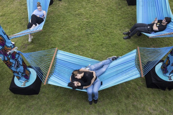 Festival visitors lying in hammocks in the Fashionpalooza at the Lollapalooza Festival in the