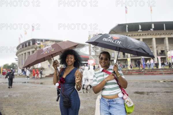 Festival visitors with Berlin umbrellas in front of the Olympic Stadium at the Lollapalooza