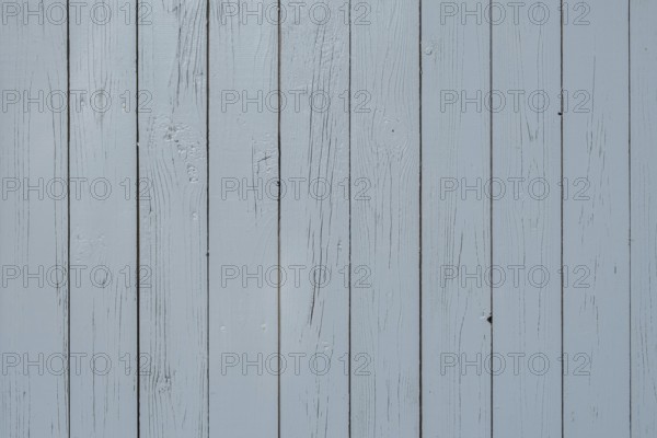 Light blue wooden wall with vertical planks and visible joints, simple and plain texture,